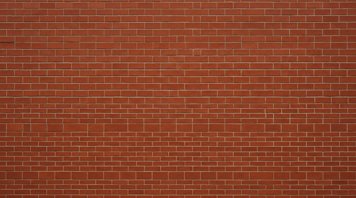 Close view of an even colored pressed brick wall with very thin mortar joints and sharp brick edges, flat daylight